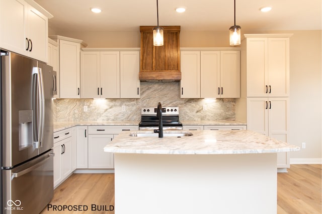 kitchen with decorative light fixtures, white cabinets, an island with sink, and stainless steel appliances