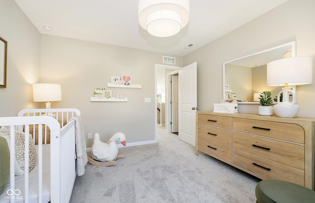 bedroom featuring light colored carpet and a crib