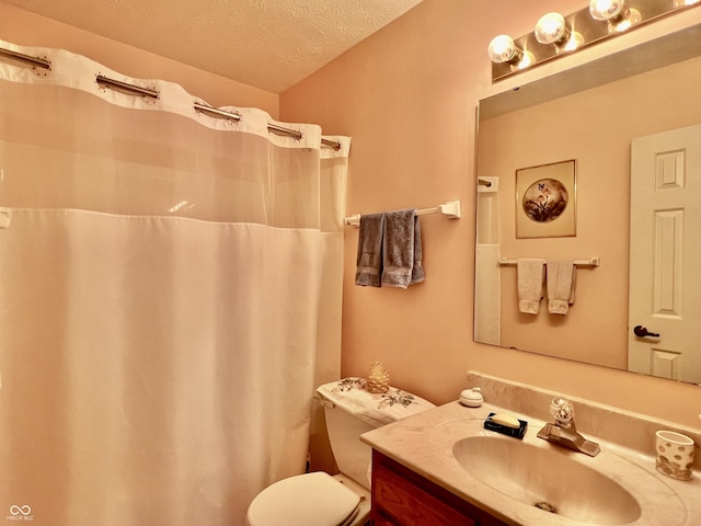 bathroom featuring a textured ceiling, toilet, and vanity