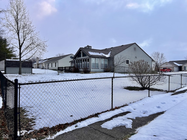 view of snowy exterior with a storage unit