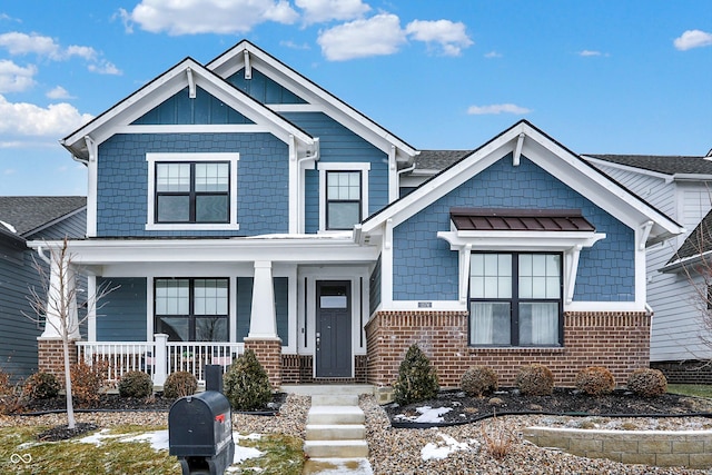 craftsman inspired home featuring covered porch