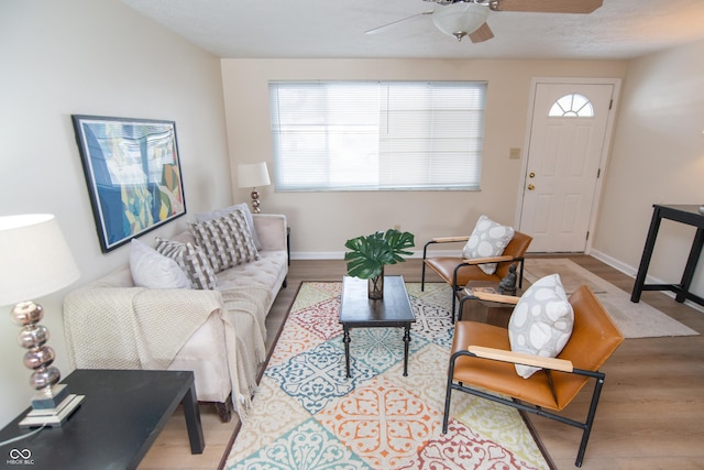 living room featuring light wood-type flooring and ceiling fan