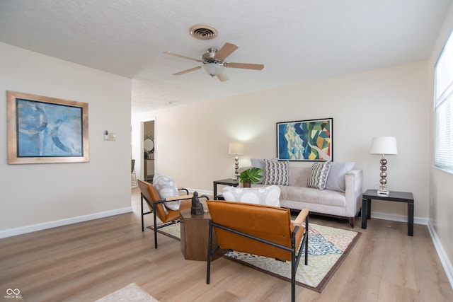 living room with ceiling fan and light wood-type flooring