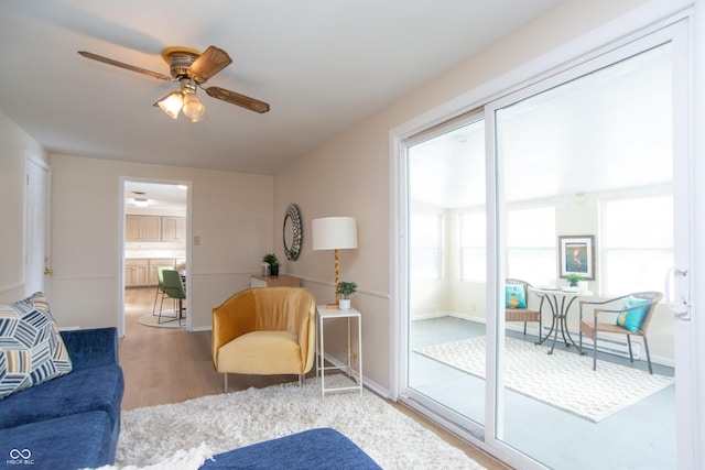 living room featuring hardwood / wood-style flooring and ceiling fan