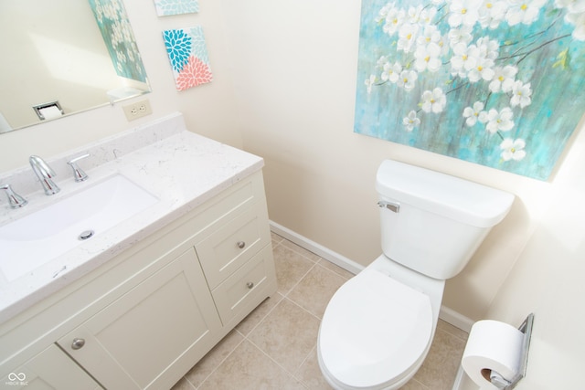 bathroom featuring toilet, tile patterned flooring, and vanity