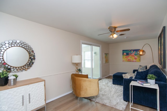 living room featuring hardwood / wood-style flooring and ceiling fan