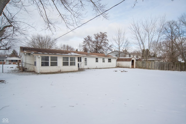 snow covered house with a shed