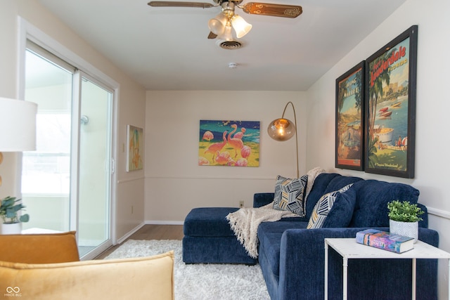 living room with light wood-type flooring and ceiling fan