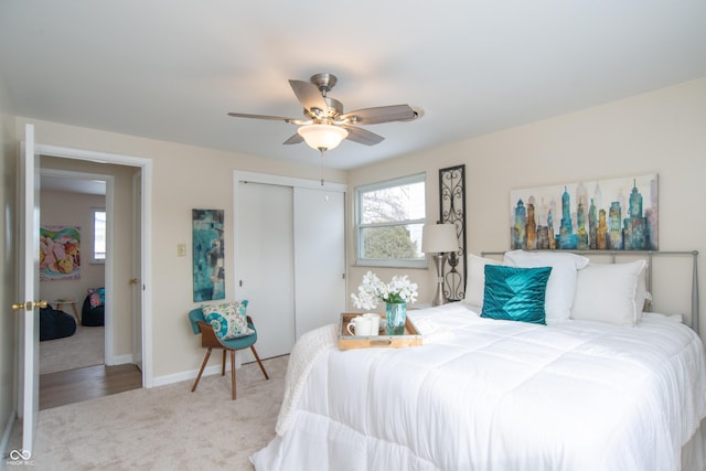 carpeted bedroom featuring multiple windows, a closet, and ceiling fan