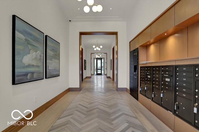 hallway featuring light parquet floors and mail boxes