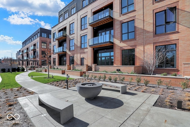 view of community featuring an outdoor fire pit