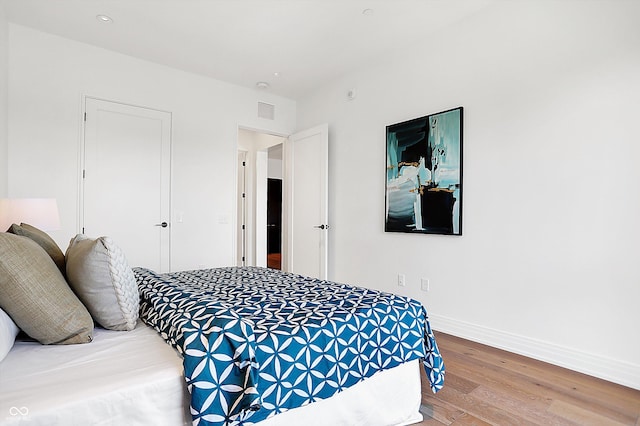 bedroom with hardwood / wood-style flooring