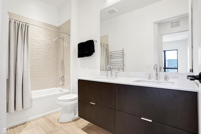 full bathroom featuring shower / bathtub combination with curtain, vanity, wood-type flooring, and toilet