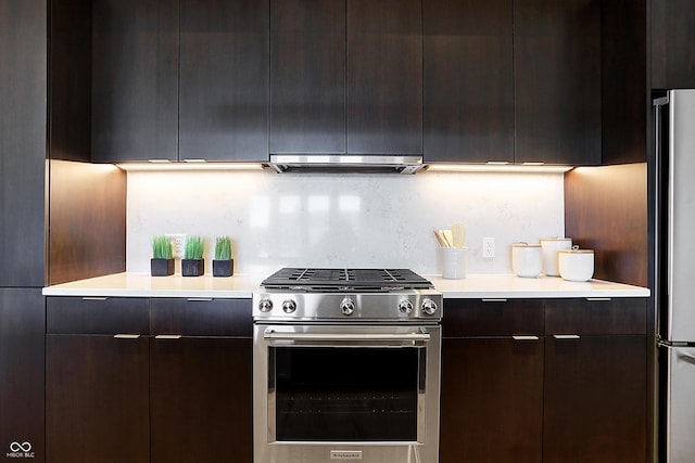 kitchen featuring tasteful backsplash, dark brown cabinetry, and appliances with stainless steel finishes