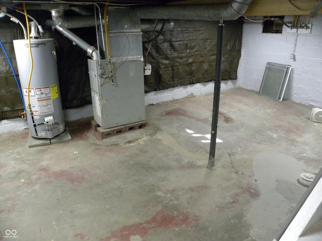 basement featuring water heater and heating unit