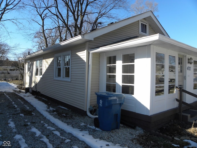 view of snowy exterior featuring french doors