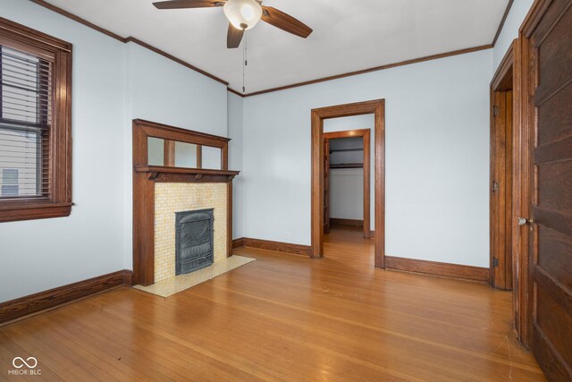 1023 Franklin St, Columbus, IN 47201 - unfurnished living room featuring ceiling fan, crown molding, and light hardwood / wood-style flooring