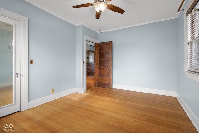 1023 Franklin St, Columbus, IN 47201 - unfurnished bedroom with ceiling fan, crown molding, and hardwood / wood-style flooring