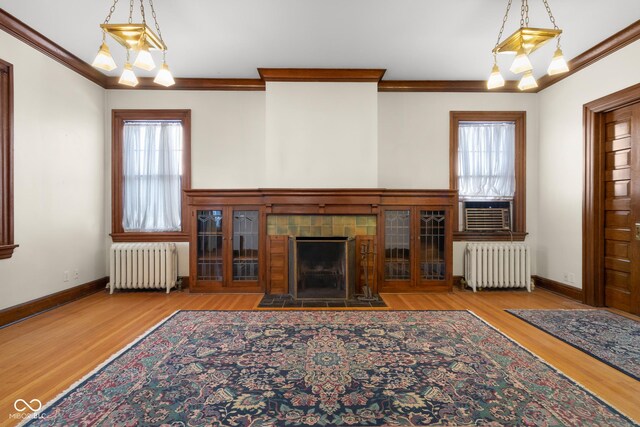 1023 Franklin St, Columbus, IN 47201 - unfurnished living room with light hardwood / wood-style floors, radiator heating unit, and a healthy amount of sunlight