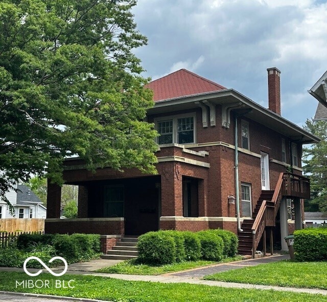 1023 Franklin St, Columbus, IN 47201 - rear view of property with stairs, brick siding, a chimney, and a porch