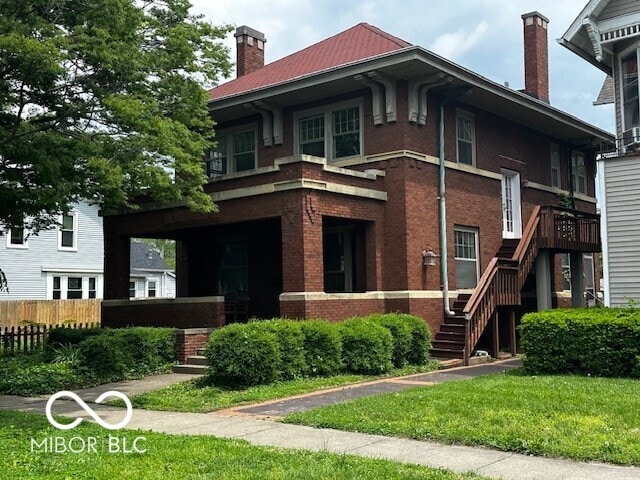 1023 Franklin St, Columbus, IN 47201 - view of front of home featuring a chimney, stairs, and brick siding