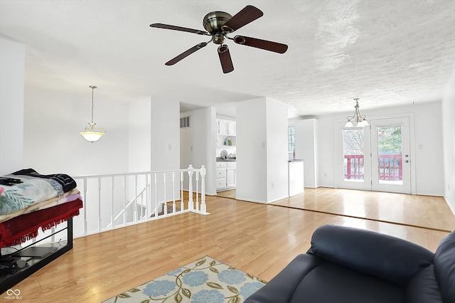 living room featuring a textured ceiling and light hardwood / wood-style flooring