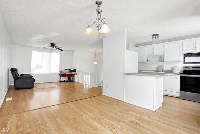 kitchen featuring stainless steel range with electric stovetop, white dishwasher, pendant lighting, and white cabinetry