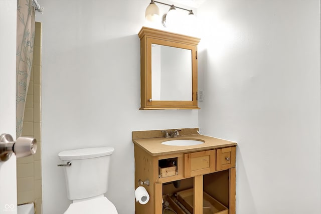 bathroom with walk in shower, vanity, and toilet