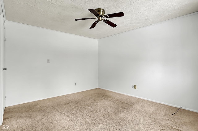 carpeted empty room with ceiling fan and a textured ceiling