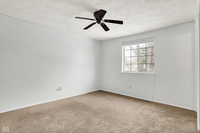 spare room featuring ceiling fan, carpet floors, and a textured ceiling