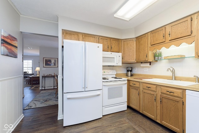 kitchen featuring tasteful backsplash, sink, white appliances, and dark wood-type flooring