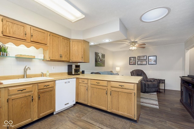 kitchen featuring kitchen peninsula, sink, dark hardwood / wood-style flooring, ceiling fan, and white dishwasher