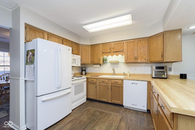 kitchen featuring dark hardwood / wood-style floors, sink, white appliances, and decorative backsplash