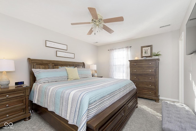 bedroom featuring light colored carpet and ceiling fan