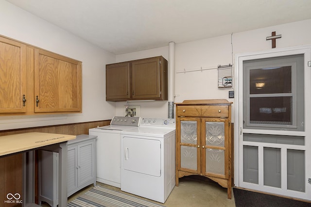 washroom with separate washer and dryer and cabinets