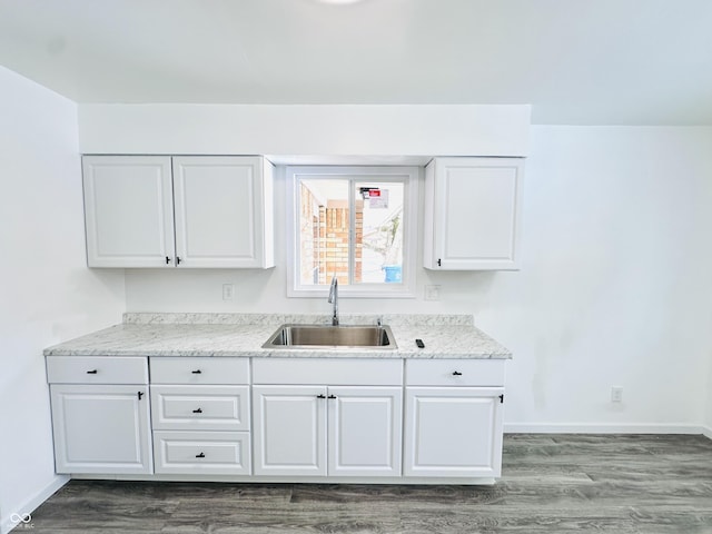 kitchen with dark wood-type flooring, sink, and white cabinetry