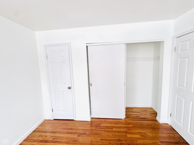 unfurnished bedroom featuring hardwood / wood-style flooring