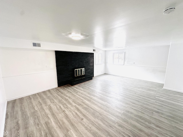 unfurnished living room featuring light hardwood / wood-style floors and a fireplace