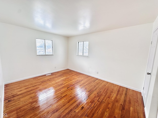 unfurnished room featuring hardwood / wood-style flooring