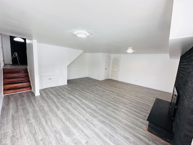 bonus room with light wood-type flooring