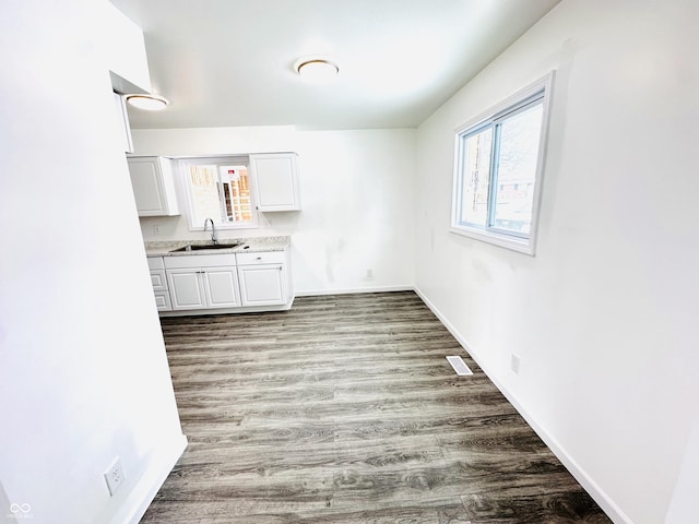 unfurnished dining area with sink and light hardwood / wood-style floors