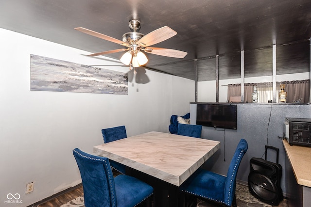 dining room featuring ceiling fan and dark hardwood / wood-style flooring