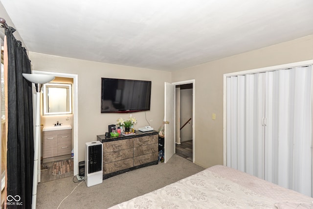 bedroom featuring sink, connected bathroom, and light colored carpet