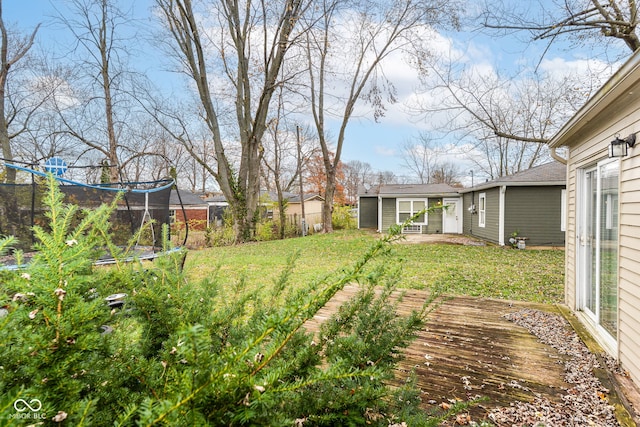 view of yard with a trampoline and an outdoor structure