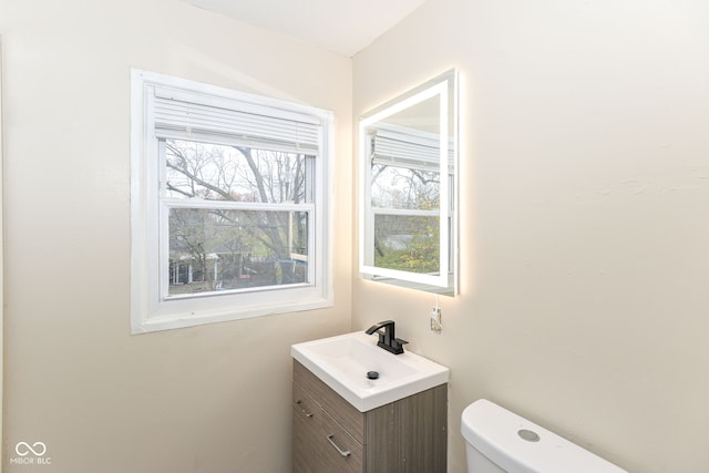 bathroom featuring toilet and vanity