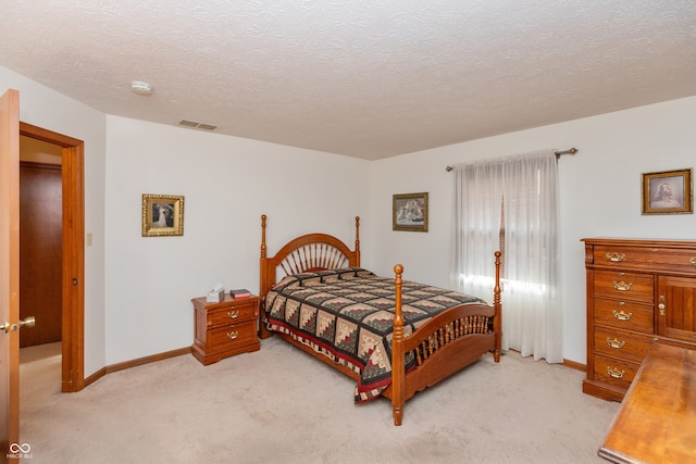 carpeted bedroom with a textured ceiling