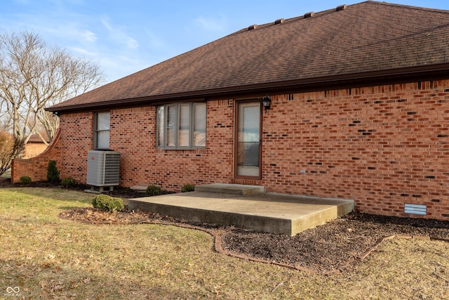 back of property with a patio, central AC unit, and a lawn