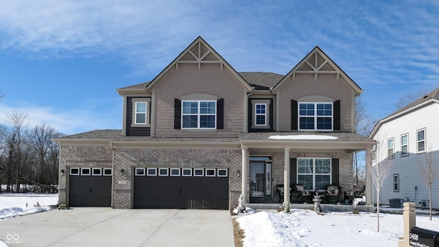 view of front facade featuring a porch and a garage