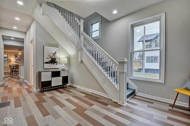 stairs with hardwood / wood-style flooring