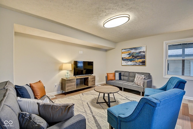 living room with hardwood / wood-style floors and a textured ceiling